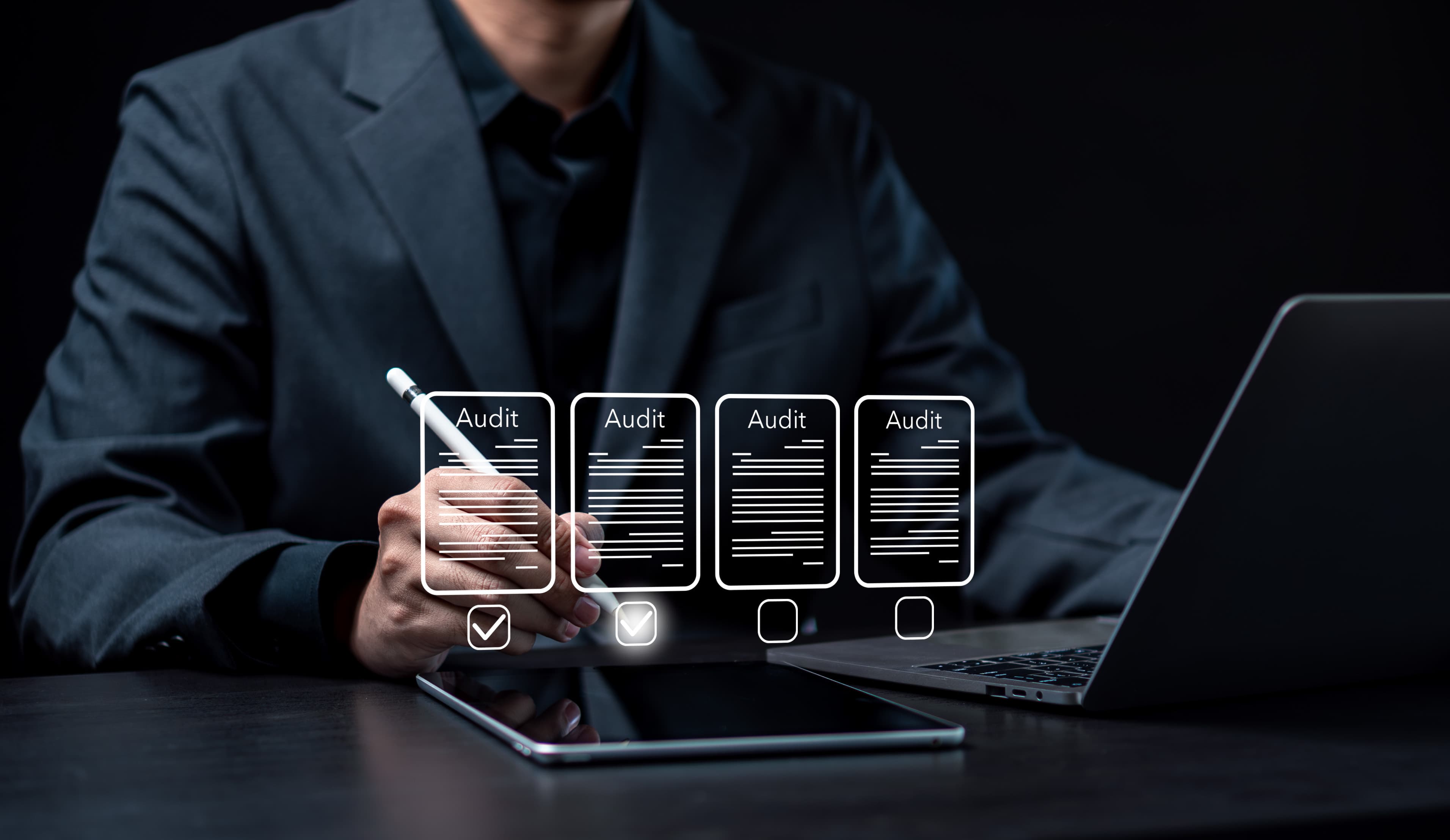 Digital audit checklist dashboard on a laptop.